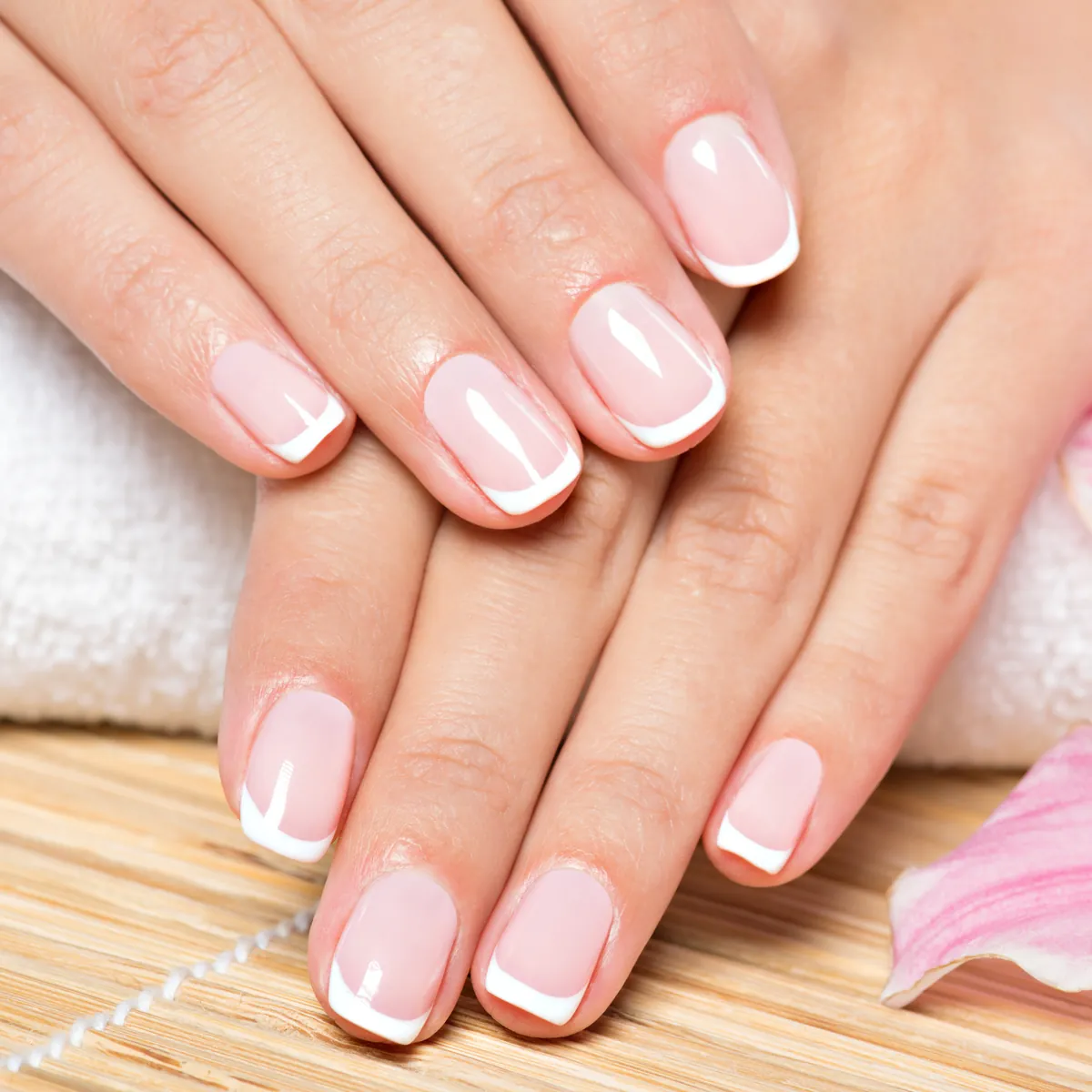 A classic French manicure with white tips on short square nails